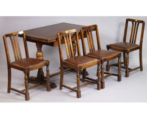 A set of four Ercol oak rail-back dining chairs, each with a padded drop-in-seat; &amp; on bulbous-turned legs with plain str