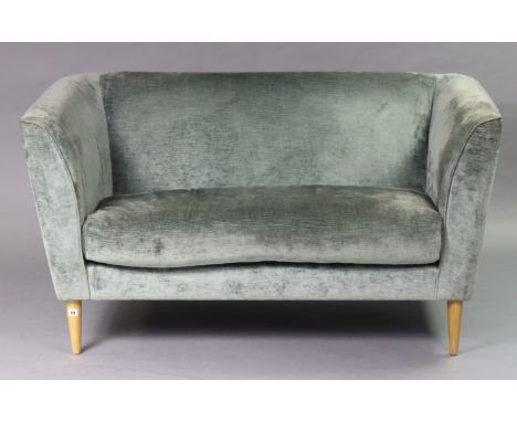 A modern two-seater sofa upholstered light grey velvet, &amp; on short round tapered legs, 141cm long (purchased from coxandc