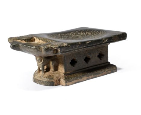 An Indian carved stone oil lamp / stand the top with an oblong depression and a welled mihrab shape end with carved birds to 