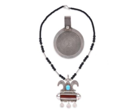 A Tuareg amulet necklace engraved white metal with carnelian and a turquoise bead, the backs with jewellers signatures, with 