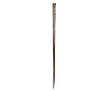 A Massim staff Trobriand Islands the finial with a carved seated figure wearing a pointed cap and with scroll decoration, 97c