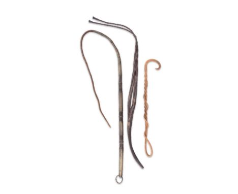 A Zulu cattle whip South Africa leather with brass wire banding, 145cm long, a leather whip with split ends, 81cm long and a 
