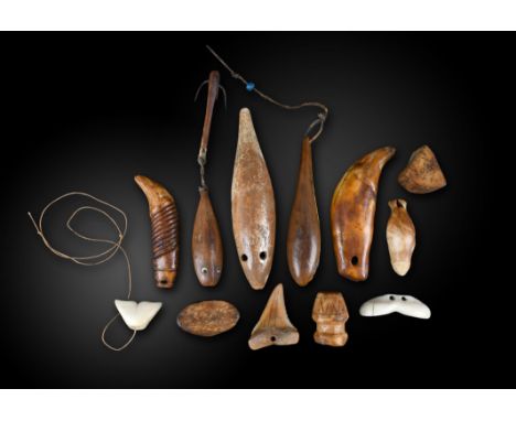 λThree Inuit fishing sinkers Alaska walrus ivory, modelled as fish, one with inset eyes and with a three spike hook, with a c