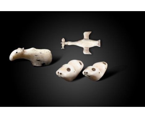 λAn Inuit caribou amulet Alaska walrus ivory, the base pierced for attachment, 5.5cm long, an Inuit carved model of a cormora