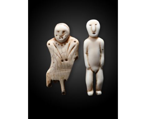 λA Inuit standing male figure Alaska marine ivory, 6.1cm high, and an Inuit comb handle fragment, marine ivory with an attach