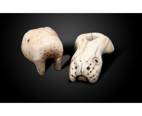 λAn Inuit amulet / implement Alaska walrus ivory, modelled as a walrus head with a triangular piercing, possibly for arrow st