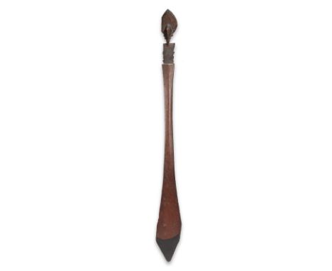 A Buka Island dance paddle Solomon Islands with a Janus head finial with a leaf shape headdress above a panel of incised conc