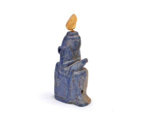 An Egyptian lapis lazuli amulet of seated Isis Late Period - Ptolemaic Period, circa 664 - 30 BC holding the infant Horus, wi