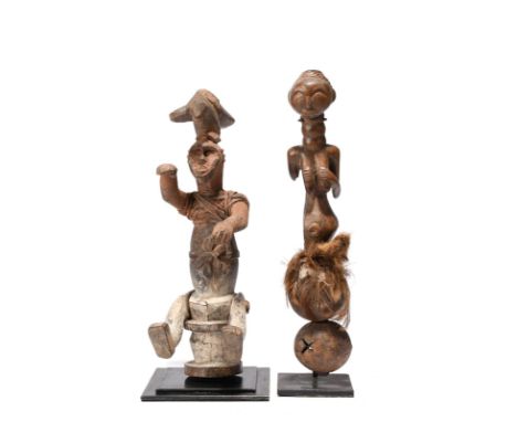 A Luba rattle Democratic Republic of the Congo with a recess to the top of a female half figure, with two nut shells and feat
