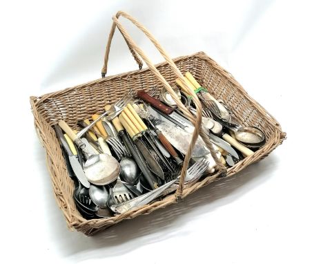 Quantity of loose flatware incl. a horn handled bread fork in a handled wicker basket 