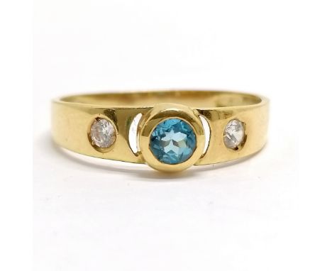 Foreign marked (touch tests as 18ct) blue topaz / white stone set ring - size R &amp; 1.7g total weight - SOLD ON BEHALF OF T