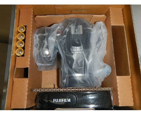 A boxed Fuji Film Fine Pix HS10 camera.