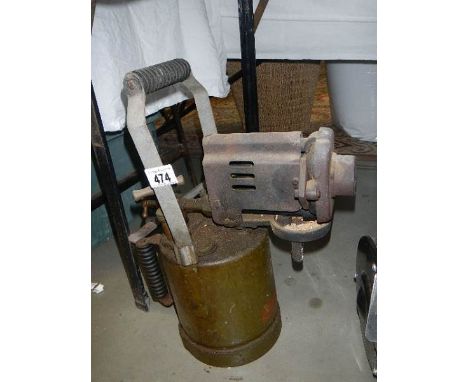 A vintage brass blow lamp.
