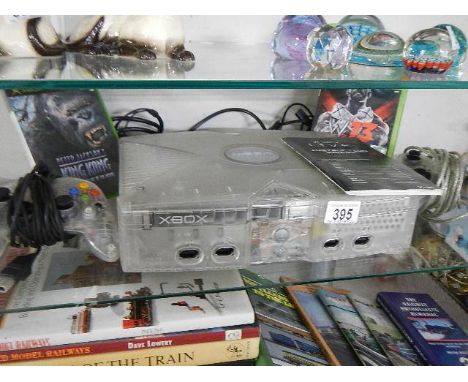 An X box console, two controls and three discs.