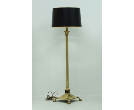 A Louis XVI style brass floor lamp with a black cylindrical shade lined in mirror paper, the fluted column terminating to a C