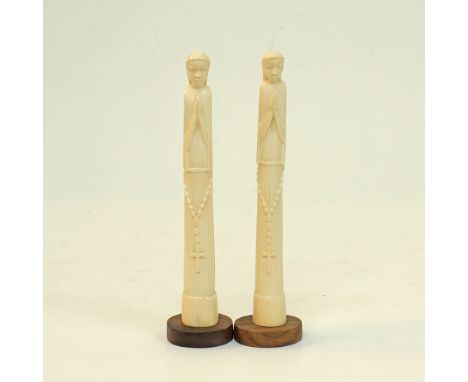 A pair of carved ivory figures of priests mounted on wooden bases, H25cm, approx.weight: 437g. Mid 20th century. (2)Provenanc