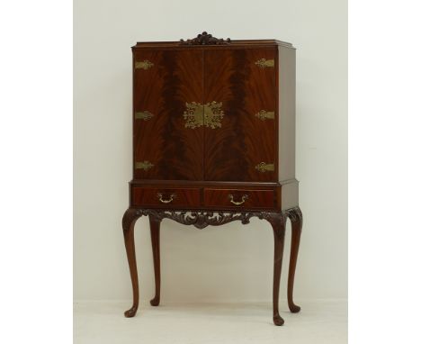 Queen Ann style mahogany cocktail cabinet, on carved cabriole legs and carved frieze, two flame mahogany doors with decorativ