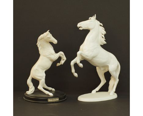 Two white porcelain figurines of prancing horses, one by Goebel H37 and one unmarked H30cm. Mid century. (2)Provenance: From 