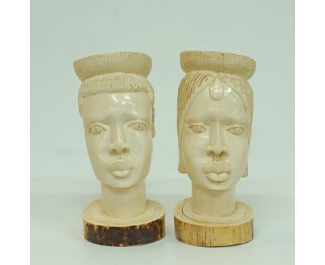 A pair of carved ivory African heads depicting a man H27cm, approx.weight: 3092g and woman H27cm, approx.weight: 3460g. Both 