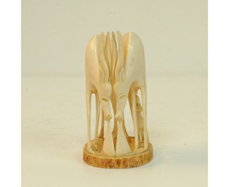 A pair of carved ivory African antelopes, one antelope with young, H17cm, W10cm, approx. weight: 565g. Mid 20th century. (2)P