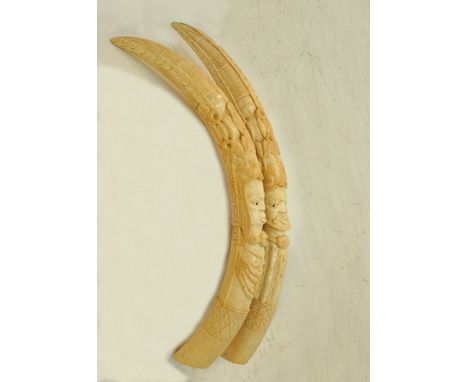 A pair of carved ivory African tusks depicting figures of a man and a woman L80cm and L74cm, approx.weight: 4780g and 4730g. 