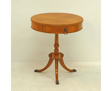 A round fruitwood drum table by Greek cabinetmaker Saridis, the top quarter veneered with feather banding, with two drawers o