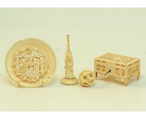 A collection of Chinese ivory carvings comprising a reticulated dish, a deity holding a ball and a reticulated box, the box H