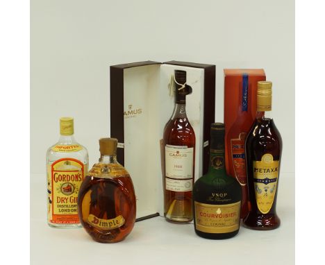 A group of five bottles of hard liquor comprising a Gordon's Dry Gin, A Dimple Whisky, a Camus 1988 Cognac, a Courvoisier VSO