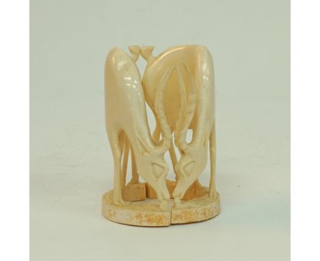 A pair of carved ivory African antelopes, both with twisted horns, H16,5cm, W12cm, approx. weight: 765g. Mid 20th century. (2
