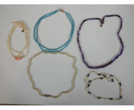 A collection of five vintage necklaces, including an amethyst graduated bead necklace, two sets of cultured pearls, a blister