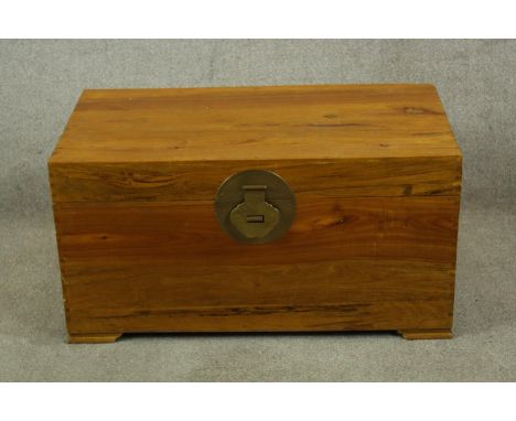 A contemporary Chinese hardwood twin handled travelling trunk raised on shaped bracket feet. H.47 W.90 D.50cm. 