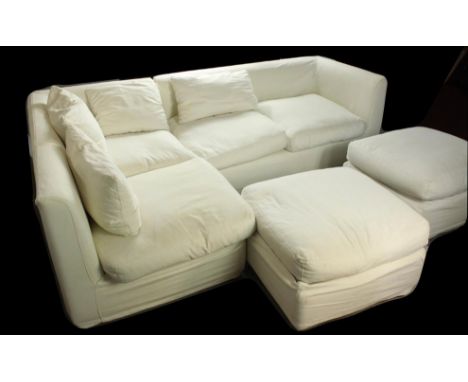 A Oka white cotton L shaped four seater settee together with two footstools. White L shaped sofa. H.73 W.240 D.163cm.