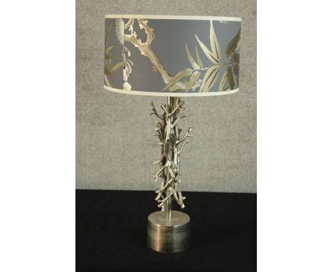 A contemporary silver painted 'intertwining twig' table lamp raised on cylindrical base with naturalistic design shade. H.63c