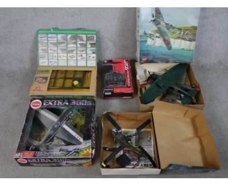 Three boxed model planes including a Cox 300s Extra, a Cox Sky Jumper helicopter and a Cox Spitfire together with a boxed sca