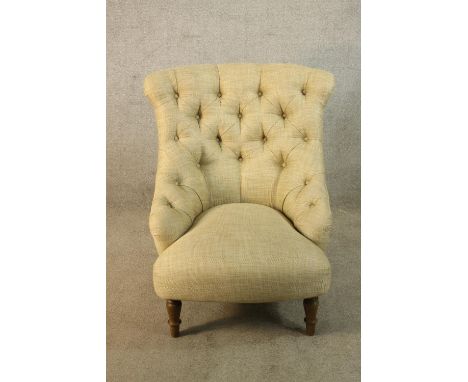 A Victorian style teak framed cream button back low nursing chair raised on turned supports H.89cm. 