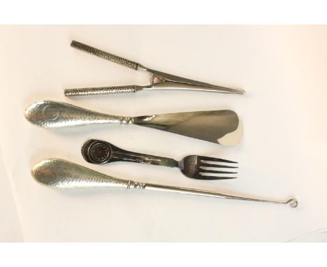 A collection of hammered silver handled tools, including boot hook, glove stretchers and shoe horn and a Danish sterling silv