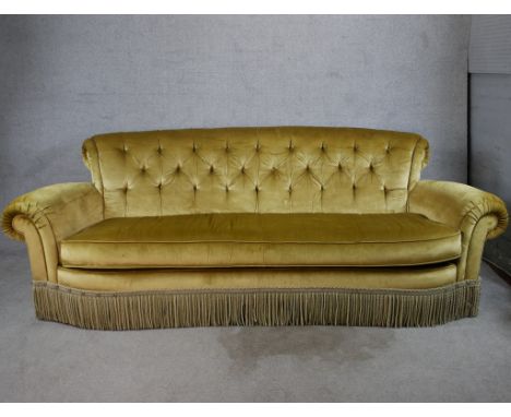A 19th century gold upholstered button back scroll arm three person sofa. H.88 W.240 D.100cm 