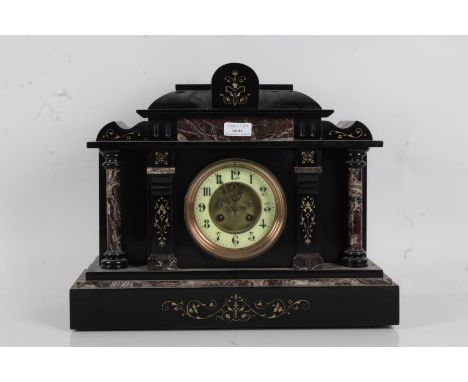 Victorian black slate mantle clock of architectural form, with a floral decorated pediment above marble columns with a white 
