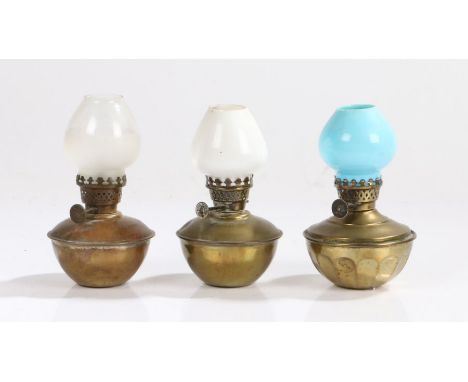 "Pixie" small oil lamp with white glass shade above a brass reservoir, 12.5cm high, "The Original Mannikin" small oil lamp wi