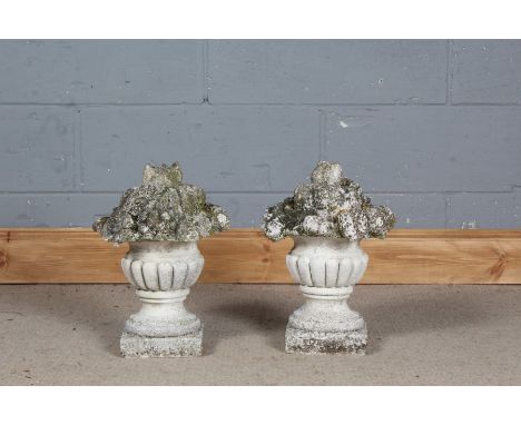 Pair of stone composite decorative gate post finials in the form of gadrooned urns full of flowers, 38cm high&nbsp;&nbsp;