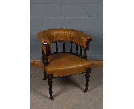 Victorian tan leatherette desk chair, the curved button back above spindle turned supports and over-stuffed seat, raised on r