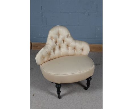 Late Victorian button back chair, having shaped back and raised on four ebonised legs and castors, 75cm wide&nbsp;