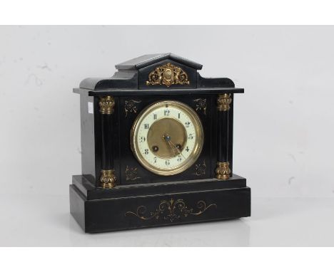 Victorian black slate mantle clock, with an arched pediment with cherubs above a pair of columns, the white dial with Arabic 