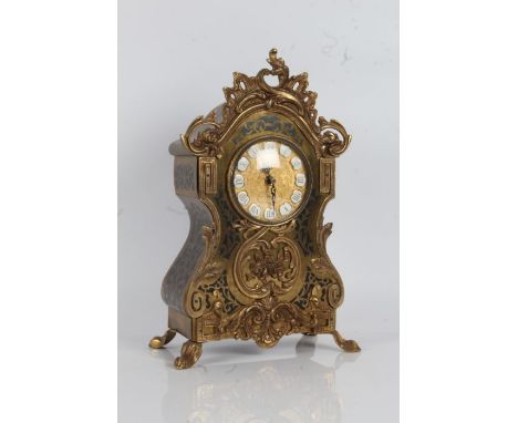 20th Century French style gilt mantle clock, with a floral pediment and floral design to the front with a gilt dial with acce