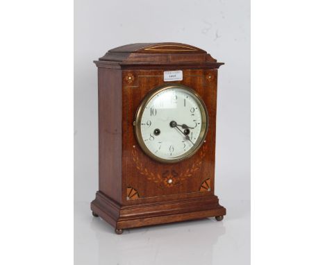 20th Century mantle clock the arched pediment with brass inlay, the front with inlaid floral design, the white dial with Arab