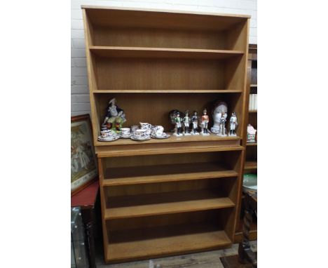 A pair of matching light oak bookcases 