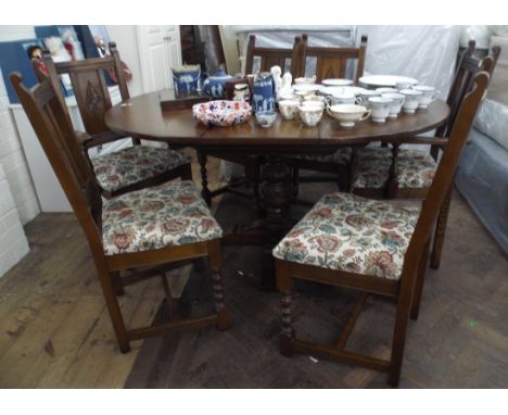 The matching old charm extending oval dining table with 6 matching chairs, comprising of two carvers and four standard chairs