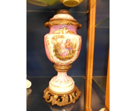 A Victorian china oil lamp having gilt metal mounts and pictorial panels  