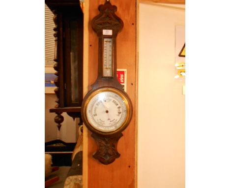 An oak cased barometer/thermometer 