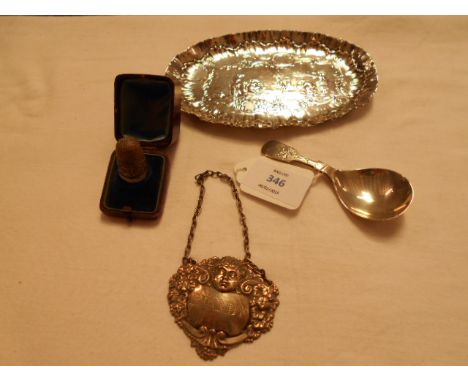 A silver thimble in a case, caddy spoons, pin tray and a brandy label 